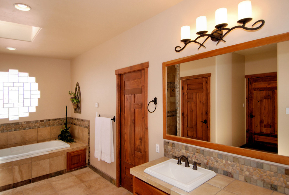 This is an example of an asian bathroom in Portland with a drop-in sink, a drop-in tub, tile benchtops and slate.