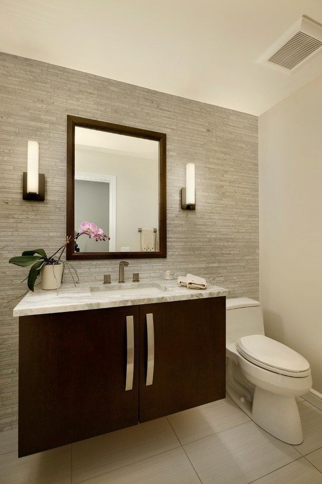 Design ideas for a mid-sized contemporary powder room in Chicago with flat-panel cabinets, dark wood cabinets, quartzite benchtops, a one-piece toilet, beige walls, an undermount sink and white benchtops.