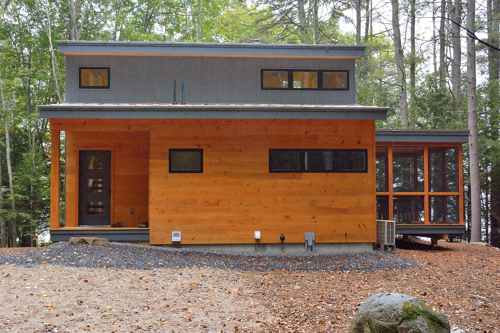 Design ideas for a small contemporary two-storey exterior in Portland Maine with a shed roof.