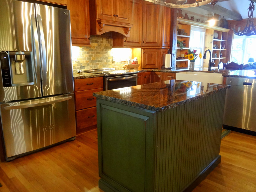 Eat-in kitchen - mid-sized rustic l-shaped medium tone wood floor eat-in kitchen idea in Charlotte with a farmhouse sink, raised-panel cabinets, dark wood cabinets, granite countertops, multicolored backsplash, stone tile backsplash, stainless steel appliances and an island