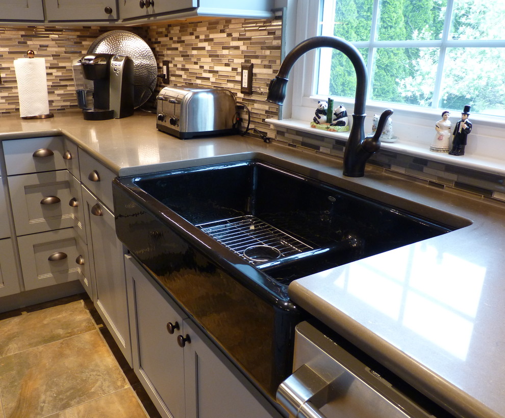 Eat-in kitchen - large transitional u-shaped porcelain tile and beige floor eat-in kitchen idea in Philadelphia with a farmhouse sink, shaker cabinets, gray cabinets, quartz countertops, gray backsplash, mosaic tile backsplash, stainless steel appliances and an island