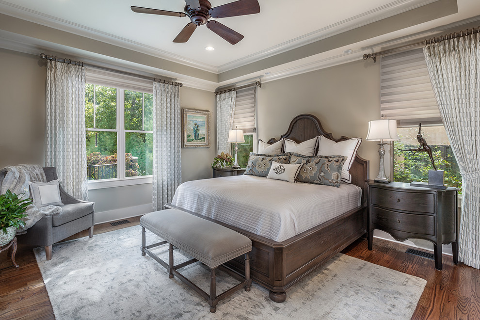 Large mountain style master dark wood floor bedroom photo with gray walls