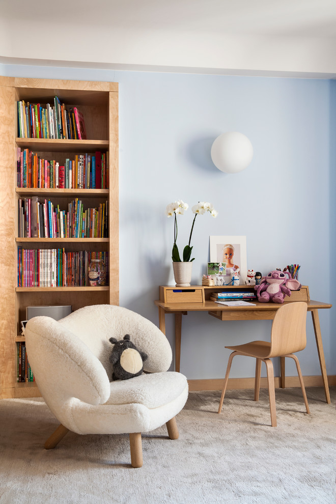 Design ideas for a mid-sized contemporary gender-neutral kids' study room for kids 4-10 years old in Paris with blue walls and carpet.
