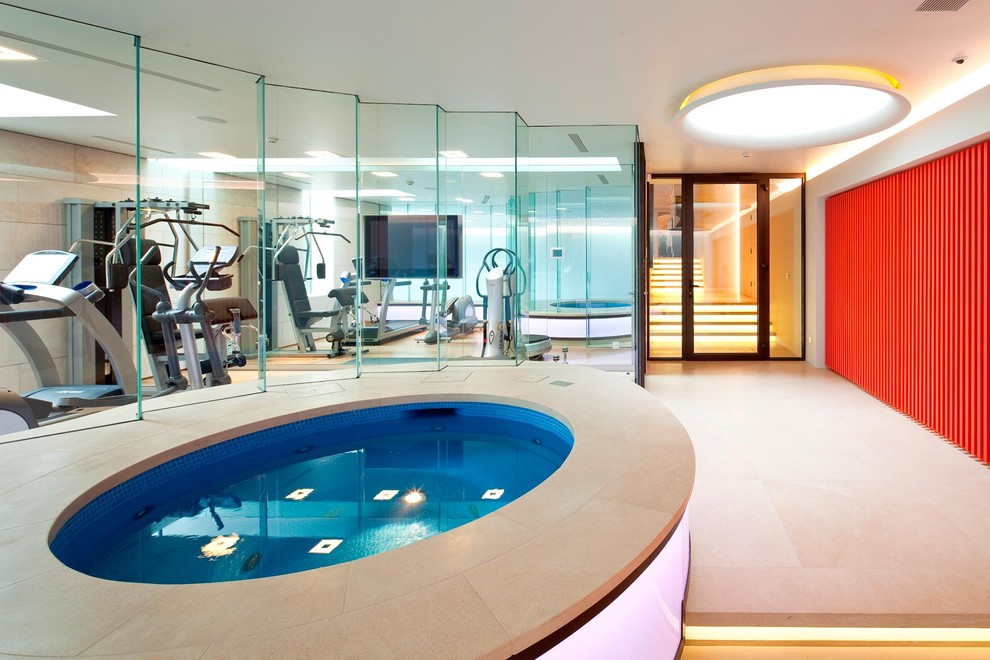 Design ideas for a small modern indoor round pool in London with a hot tub and tile.