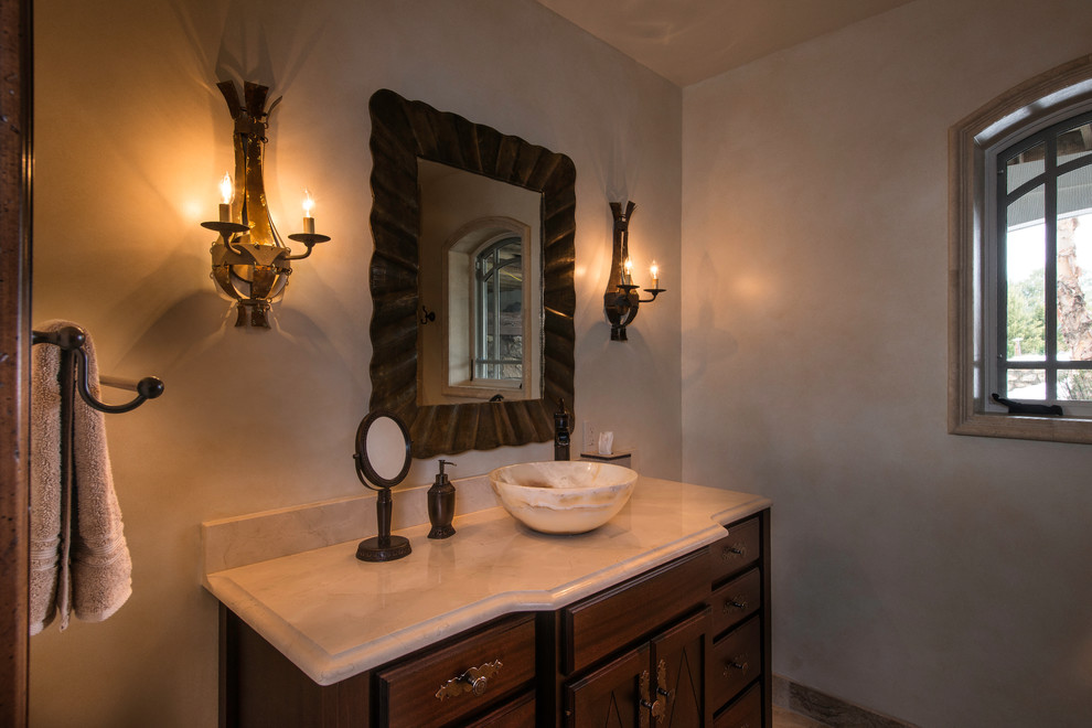 Design ideas for a traditional bathroom in DC Metro with a vessel sink, raised-panel cabinets, dark wood cabinets, marble benchtops, an open shower, white tile, stone tile, limestone floors, beige walls and beige floor.