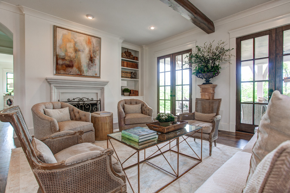 Large traditional formal open concept living room in Little Rock with white walls, medium hardwood floors, a standard fireplace, a plaster fireplace surround and no tv.