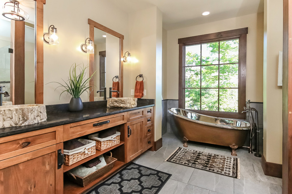 Photo of a country bathroom in Other with a vessel sink, shaker cabinets and a claw-foot tub.