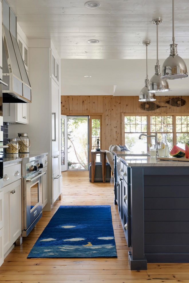 Inspiration for a small coastal single-wall shiplap ceiling open concept kitchen remodel in Minneapolis with a farmhouse sink, shaker cabinets, white cabinets, granite countertops, blue backsplash, subway tile backsplash, paneled appliances, an island and white countertops