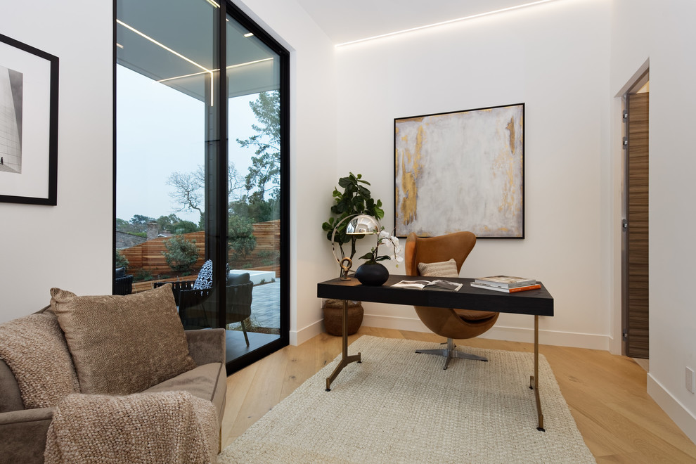 Study room - large modern light wood floor and beige floor study room idea in San Francisco with white walls