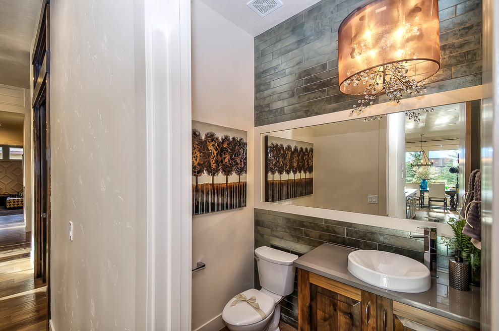 Inspiration for a small rustic master multicolored tile and porcelain tile medium tone wood floor bathroom remodel in Boise with a drop-in sink, raised-panel cabinets, medium tone wood cabinets, quartz countertops and white walls