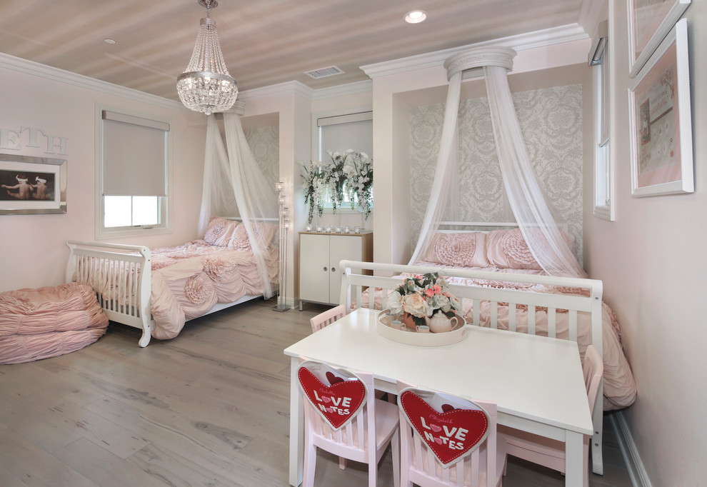 Mid-sized traditional kids' bedroom in Orange County with pink walls, light hardwood floors and grey floor for kids 4-10 years old and girls.