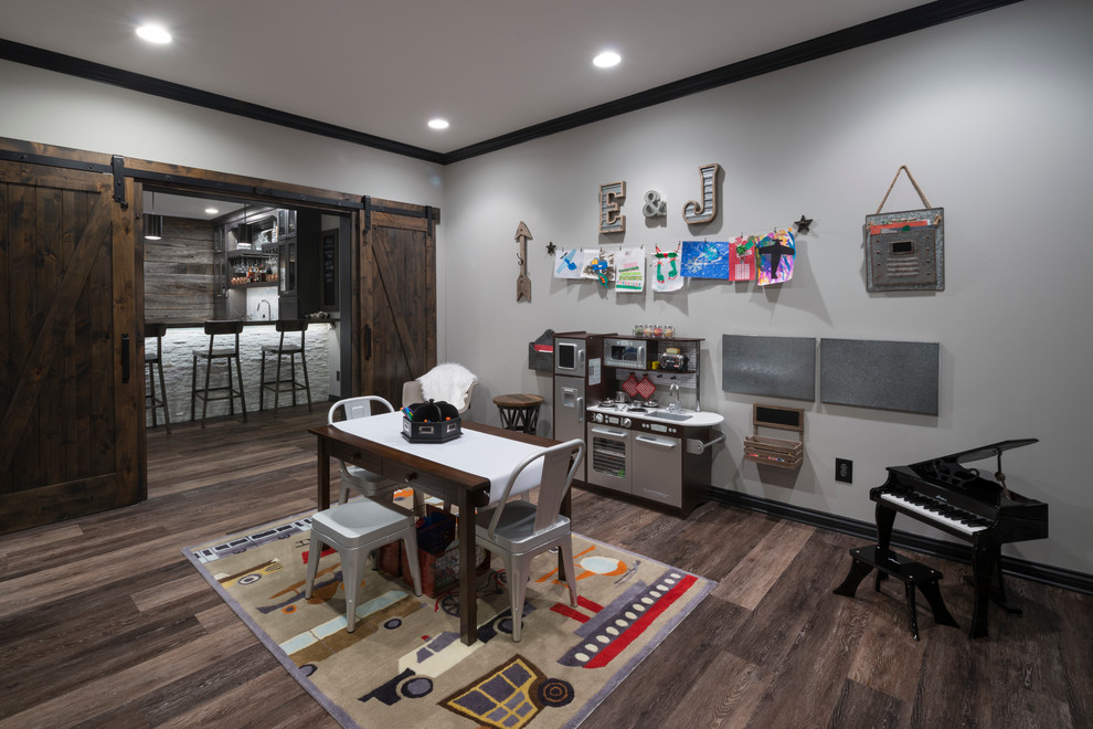Photo of a country gender-neutral kids' playroom for kids 4-10 years old in Indianapolis with grey walls and dark hardwood floors.