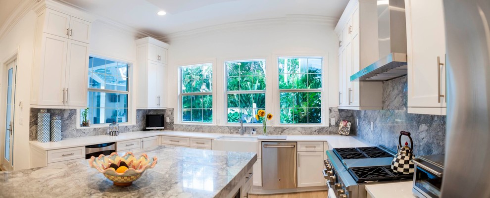 Large transitional u-shaped eat-in kitchen photo with shaker cabinets, white cabinets and an island
