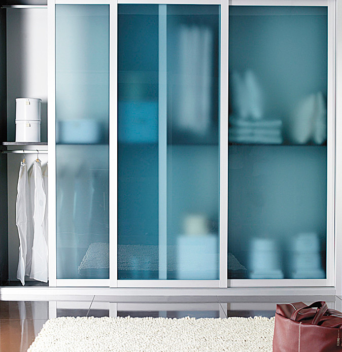 Design ideas for a small transitional gender-neutral walk-in wardrobe in Other with glass-front cabinets.