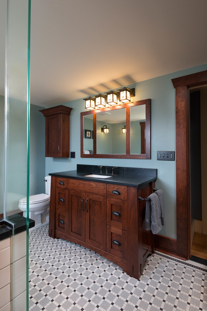 Inspiration for a mid-sized arts and crafts master bathroom in Detroit with shaker cabinets, dark wood cabinets, a freestanding tub, an alcove shower, a two-piece toilet, black and white tile, porcelain tile, green walls, mosaic tile floors, an undermount sink and soapstone benchtops.