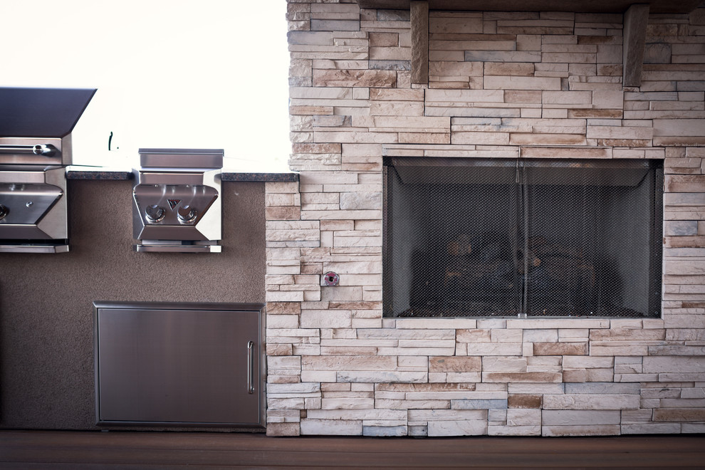 Huge mountain style backyard outdoor kitchen deck photo in Indianapolis with a roof extension