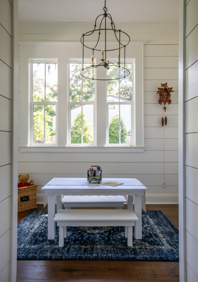 Playroom - farmhouse gender-neutral medium tone wood floor and brown floor playroom idea in Jacksonville with white walls