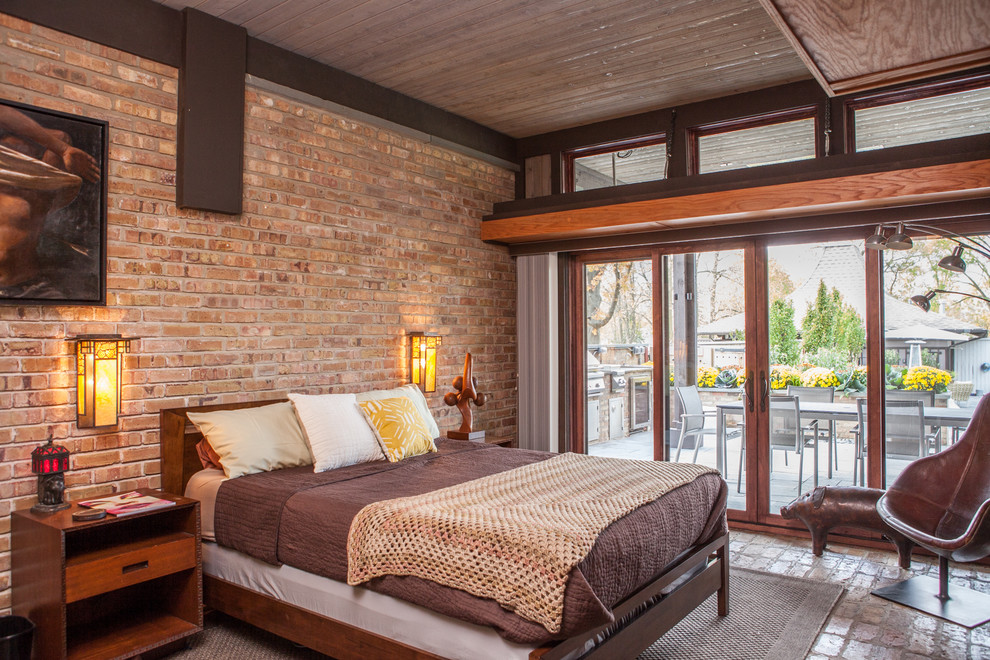 Inspiration for an eclectic bedroom in Chicago with brick floors and brown walls.