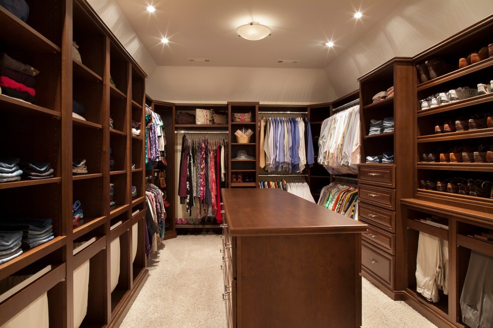 Inspiration for a mid-sized modern men's dressing room in Cincinnati with medium wood cabinets, carpet, raised-panel cabinets and beige floor.