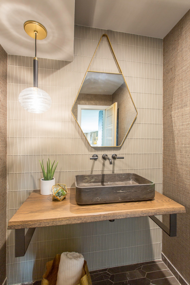 Photo of a small contemporary powder room in Denver with a one-piece toilet, glass tile, marble floors, a vessel sink, wood benchtops, brown benchtops, a floating vanity and wallpaper.