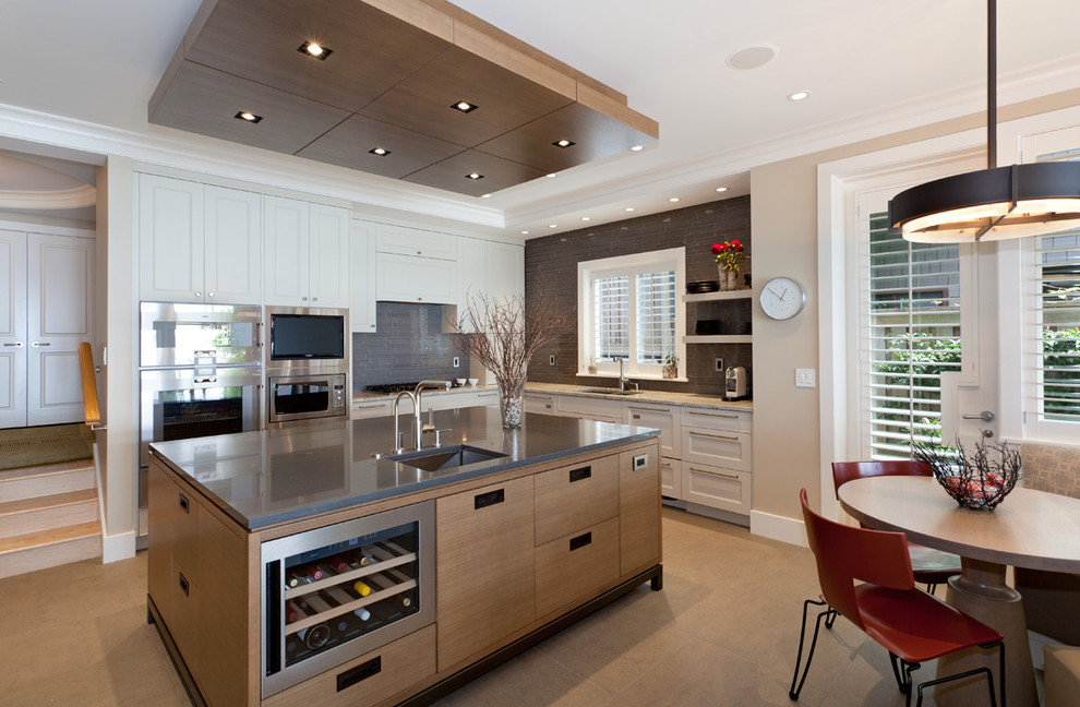 Design ideas for a contemporary kitchen in Vancouver with stainless steel appliances and beige floor.