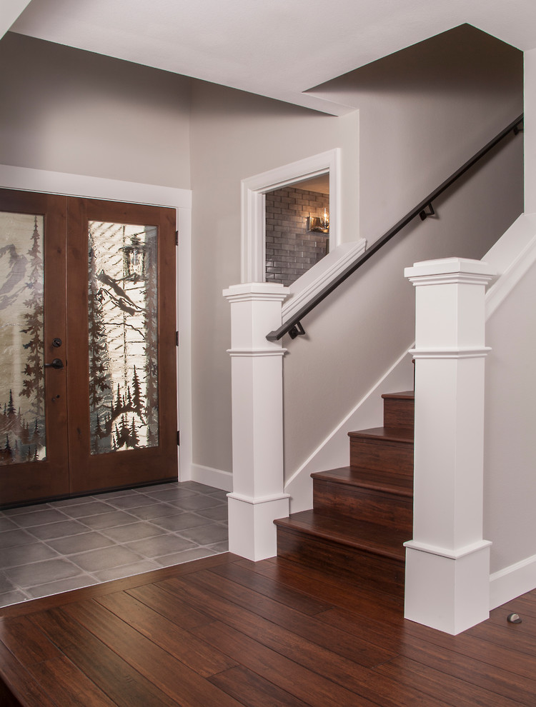 Inspiration for a mid-sized arts and crafts foyer in Seattle with porcelain floors, a double front door, a medium wood front door and grey floor.