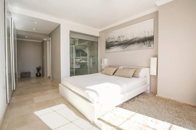 Mid-sized scandinavian master bedroom in Madrid with beige walls, porcelain floors and no fireplace.