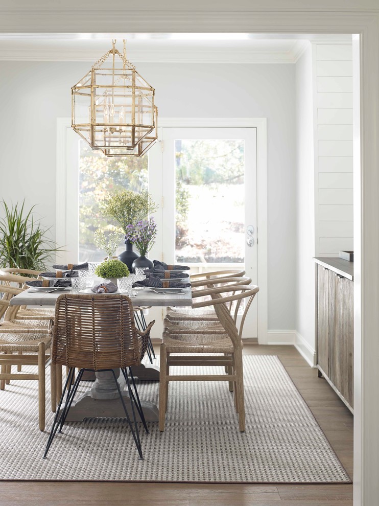 Inspiration for a transitional separate dining room in Raleigh with white walls, medium hardwood floors, no fireplace and brown floor.