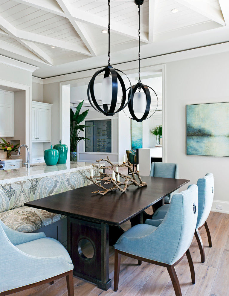 Beach style dining room in Miami with light hardwood floors and beige walls.