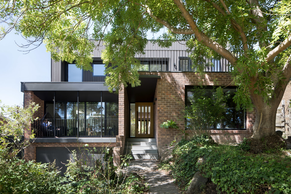 Mid-sized contemporary three-storey brown exterior in Melbourne with mixed siding and a flat roof.