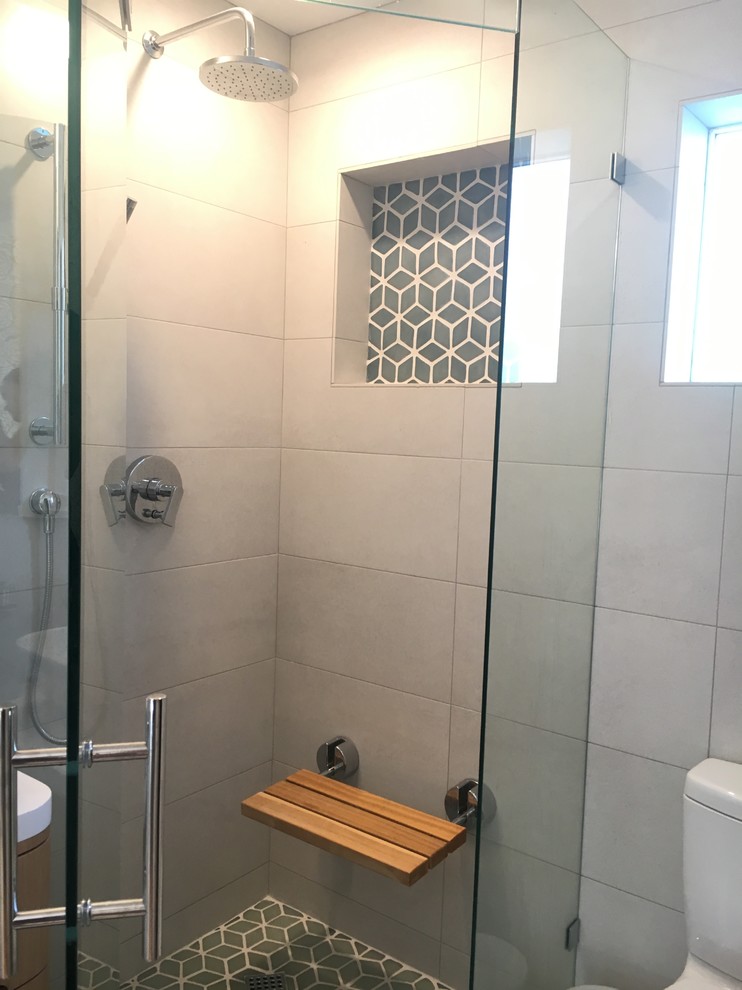 Photo of a small contemporary master bathroom in Santa Barbara with furniture-like cabinets, light wood cabinets, a corner shower, white tile, porcelain tile, white walls, porcelain floors, a vessel sink, quartzite benchtops, white floor and a hinged shower door.