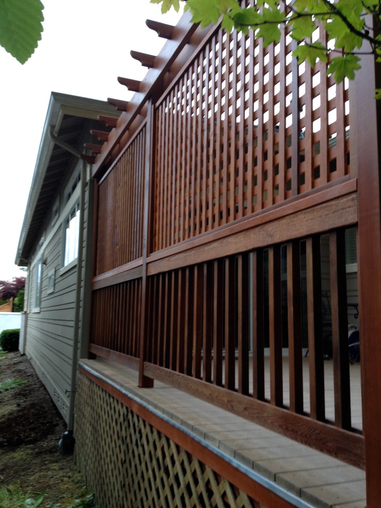 Example of a backyard deck design in Seattle with no cover