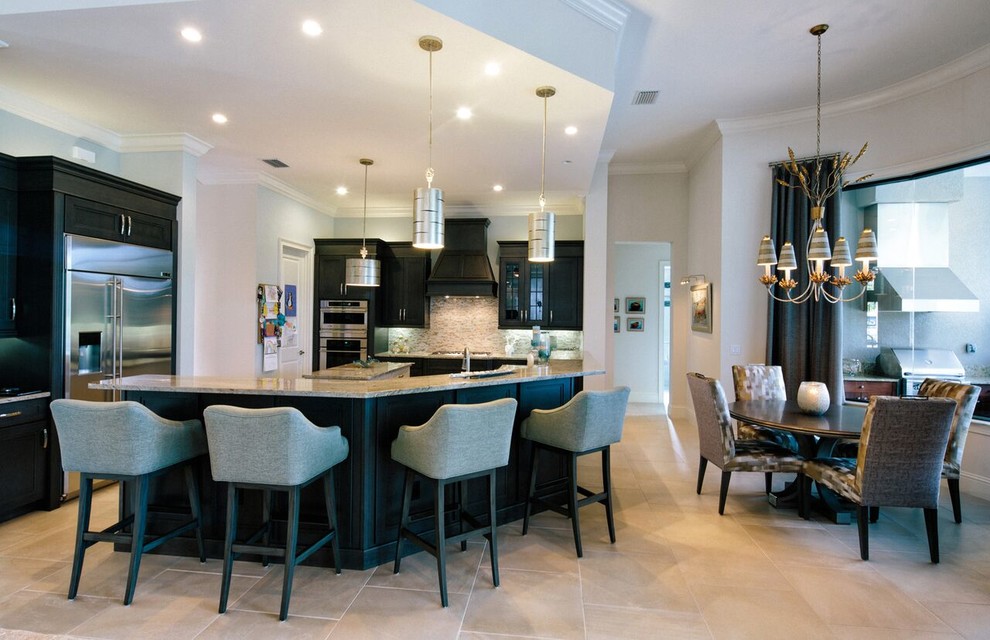 Large transitional l-shaped travertine floor and beige floor eat-in kitchen photo in Miami with an undermount sink, recessed-panel cabinets, dark wood cabinets, quartz countertops, beige backsplash, matchstick tile backsplash, stainless steel appliances and two islands