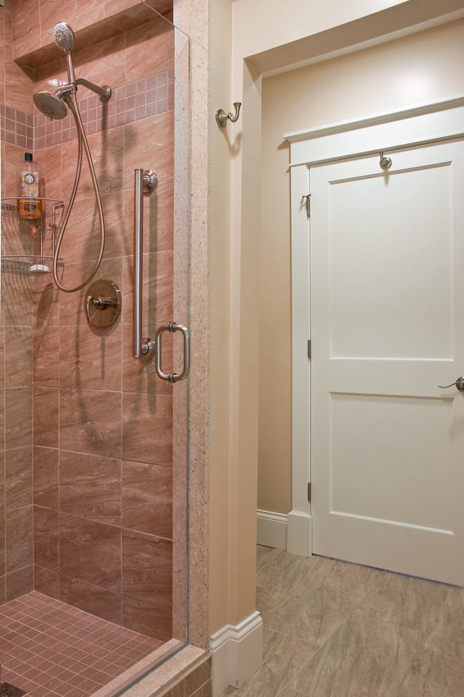 Inspiration for a mid-sized transitional 3/4 bathroom in Other with a two-piece toilet, beige tile, beige walls, an alcove shower, beige floor and a hinged shower door.