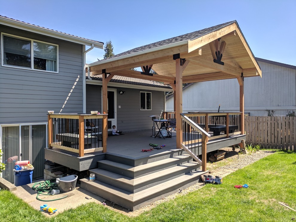 Inspiration for a large transitional backyard deck in Seattle with a pergola.