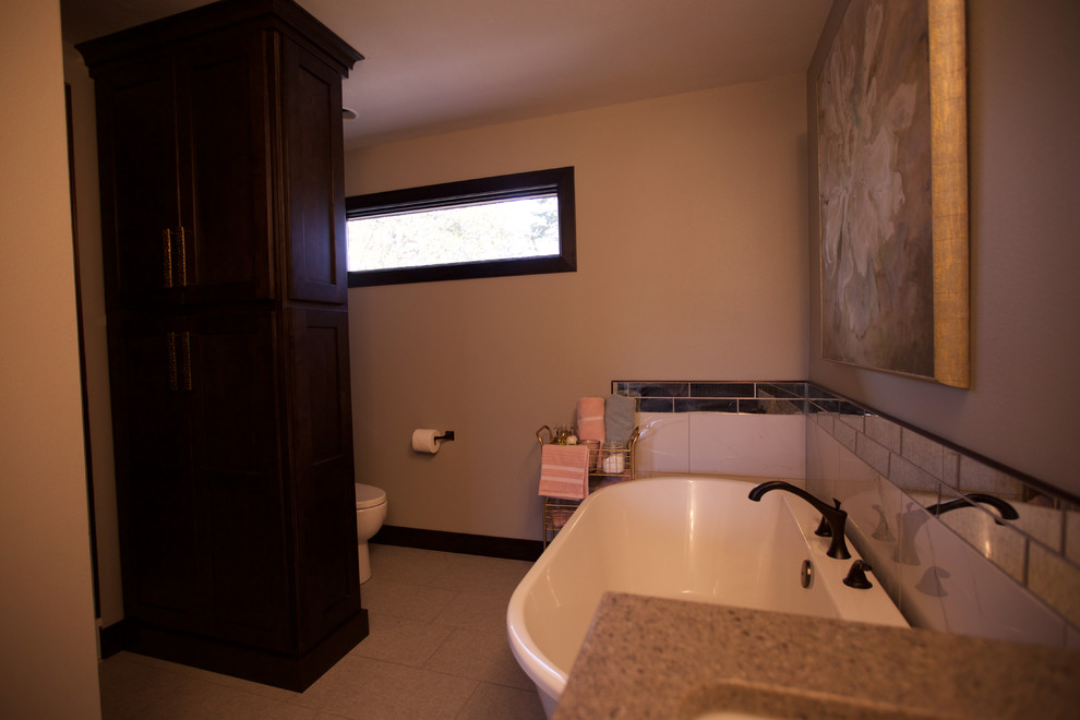 Mid-sized transitional master white tile and ceramic tile ceramic tile and gray floor freestanding bathtub photo with shaker cabinets, black cabinets, a bidet, gray walls, an undermount sink and quartzite countertops