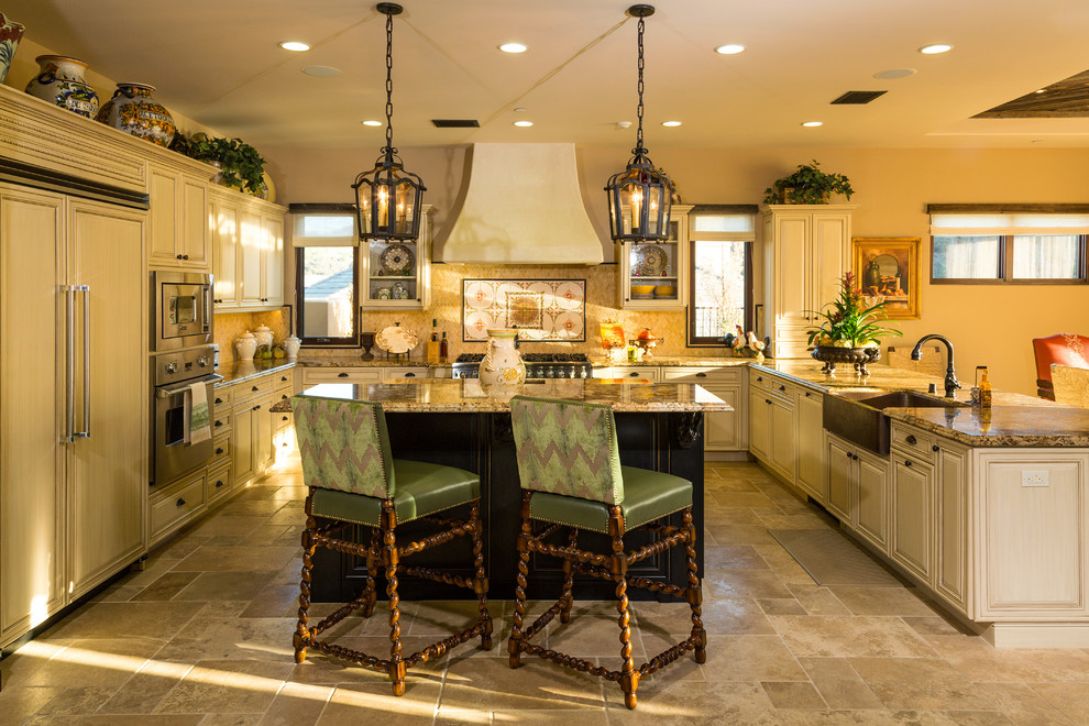 Large mediterranean u-shaped eat-in kitchen in Los Angeles with light wood cabinets, a farmhouse sink, recessed-panel cabinets, multi-coloured splashback, panelled appliances and with island.