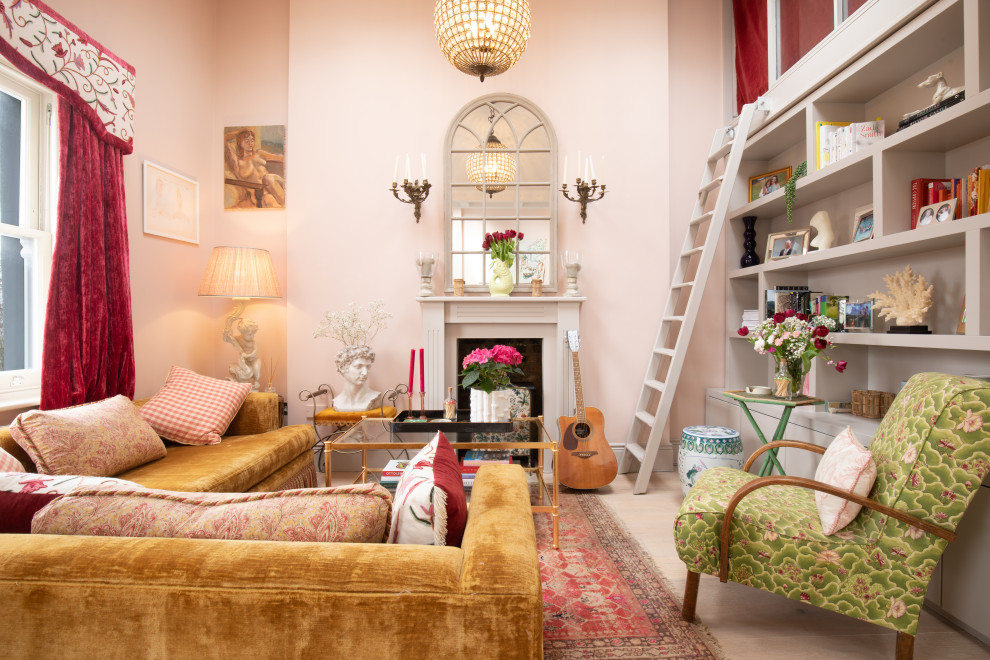 Design ideas for a mid-sized eclectic formal open concept living room in London with pink walls, light hardwood floors, a standard fireplace, a wood fireplace surround, no tv, beige floor, vaulted and wallpaper.