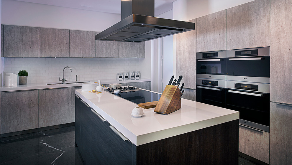 Photo of a mid-sized modern l-shaped eat-in kitchen in Other with an undermount sink, raised-panel cabinets, grey cabinets, limestone benchtops, white splashback, cement tile splashback, stainless steel appliances, marble floors and with island.