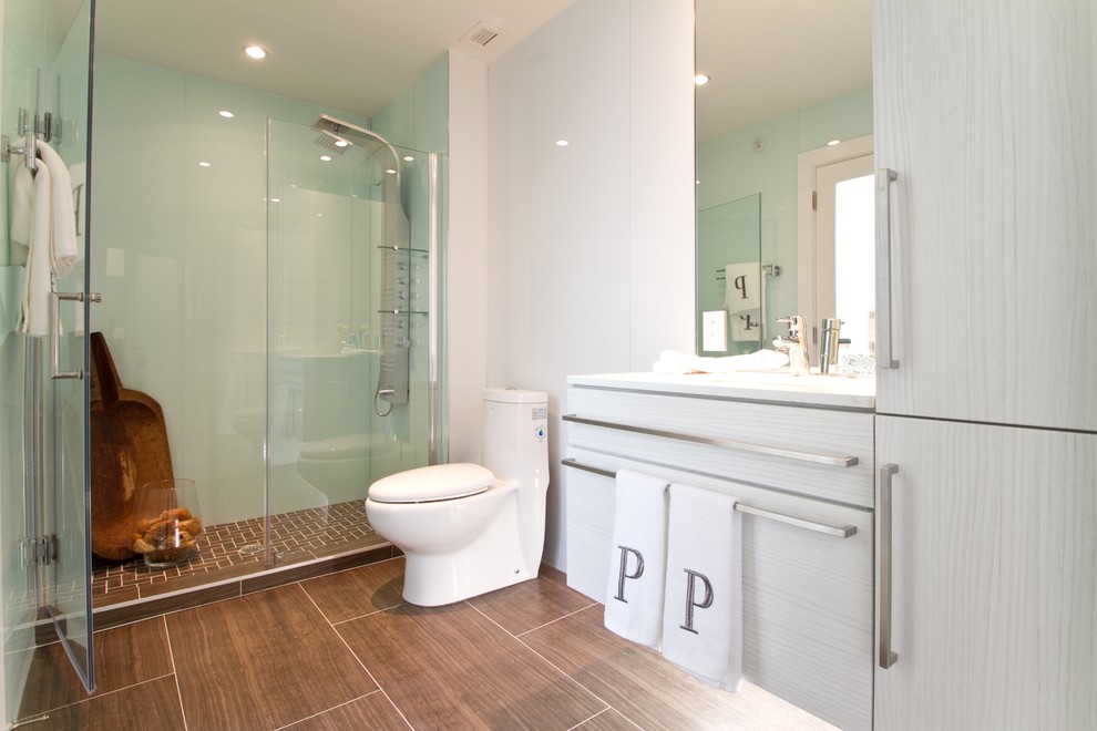 This is an example of a contemporary bathroom in Philadelphia with ceramic tile, flat-panel cabinets, grey cabinets, an alcove shower and a one-piece toilet.