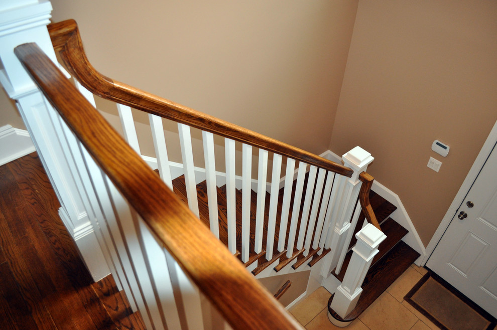 Large contemporary wood l-shaped staircase in New York with wood risers.