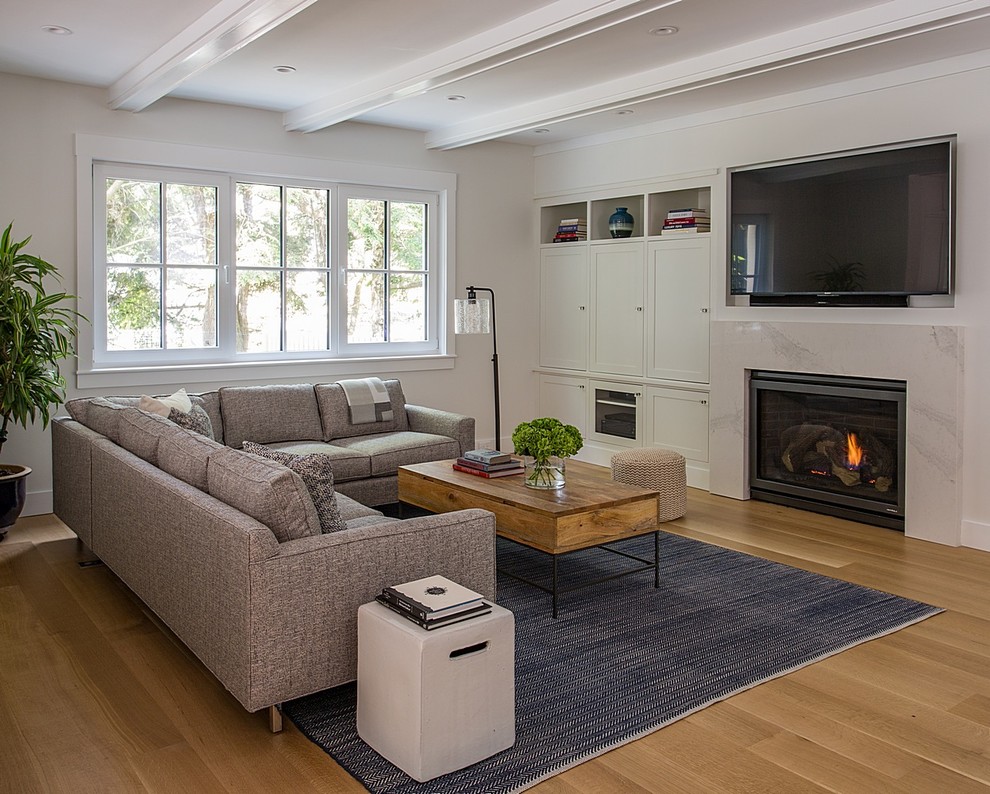 Inspiration for a mid-sized contemporary open concept medium tone wood floor and brown floor living room remodel in Boston with white walls, a standard fireplace, a stone fireplace and a wall-mounted tv