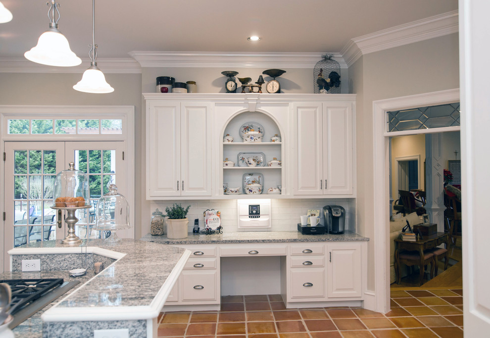 Photo of a mid-sized traditional u-shaped kitchen pantry in Atlanta with a single-bowl sink, raised-panel cabinets, white cabinets, granite benchtops, white splashback, stone tile splashback, stainless steel appliances, terra-cotta floors and with island.