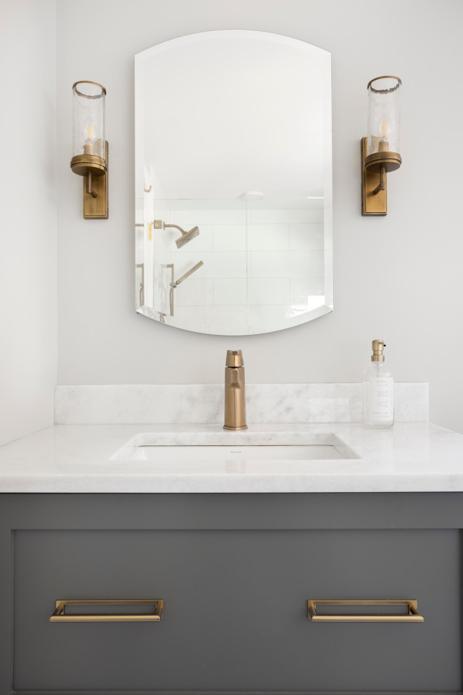 Example of a mid-sized transitional 3/4 white tile and ceramic tile mosaic tile floor, white floor, single-sink and vaulted ceiling alcove shower design in Portland with shaker cabinets, gray cabinets, gray walls, an undermount sink, marble countertops, a hinged shower door, white countertops, a niche and a freestanding vanity