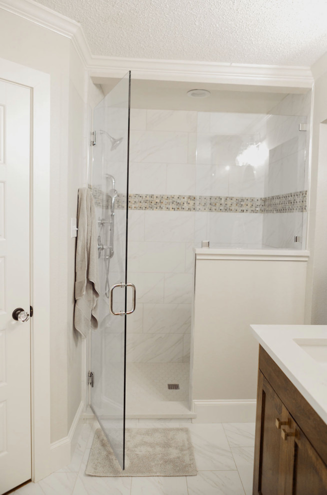 Freestanding bathtub - mid-sized modern master white tile porcelain tile and white floor freestanding bathtub idea in Dallas with flat-panel cabinets, brown cabinets, white walls, quartzite countertops, a hinged shower door and white countertops