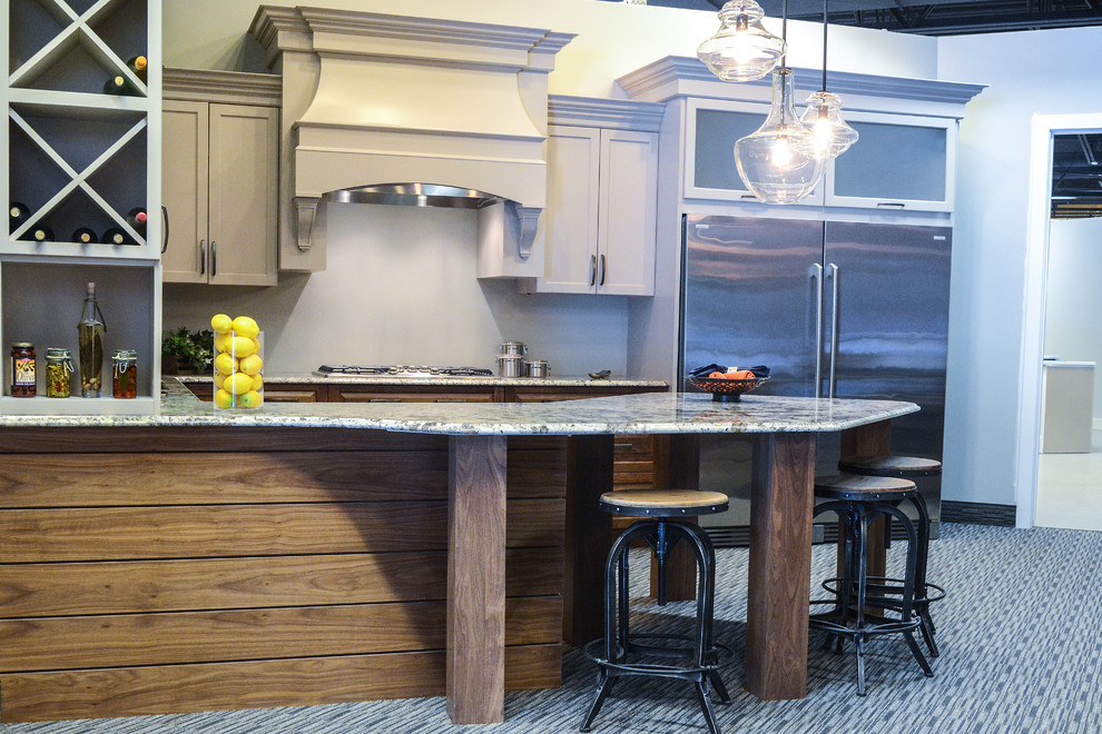 Large transitional carpeted eat-in kitchen photo with an undermount sink, flat-panel cabinets, gray cabinets, laminate countertops, gray backsplash and stainless steel appliances