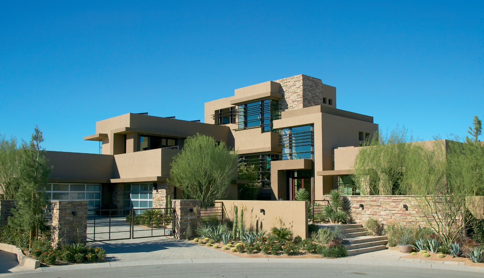 Photo of an expansive contemporary three-storey house exterior in Las Vegas with a flat roof.