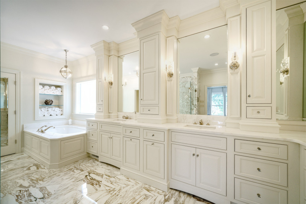 This is an example of a traditional master bathroom in Other with beaded inset cabinets, white cabinets, an undermount tub, white walls, an undermount sink, white floor and white benchtops.