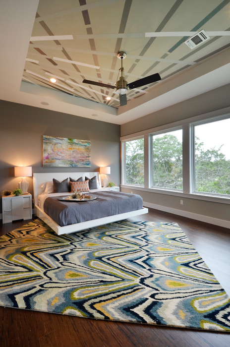 Inspiration for a mid-sized contemporary master bedroom in Austin with grey walls, bamboo floors and no fireplace.