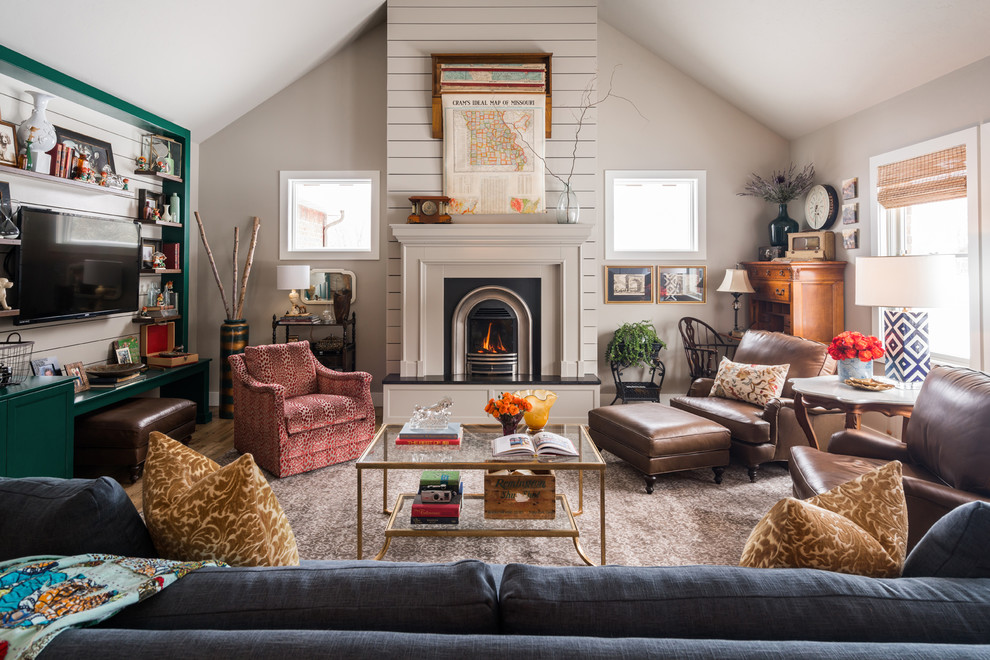 Inspiration for a mid-sized traditional family room in Other with a library, grey walls, a standard fireplace and a wall-mounted tv.